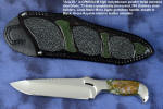 "Axia EL" fine handmade knife obverse side view  in T3 deep cryogenically treated CPM 154CM high mollybdenum powder metal technology martensitic stainless steel blade, 304 stainless steel bolsters, Linda Marie Moss Agate gemstone handle, hand-carved leather shoulder inlaid with green, black ray skin