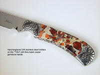 "Trifid" obverse side view in 440C high chromium stainless steel blade, hand-engraved 304 stainless steel bolsters, Brecciated Jasper gemstone handle, Ostrich leg skin inlaid in hand-carved leather sheath