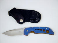 "Stratos" liner lock folding knife, obverse side view: 440C stainless steel blade, anodized 6AL4V titanium liners, leather, nickel plated steel sheath